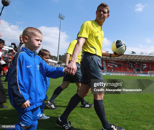 Referee Michael Kempter enters the field for the Third League match between SV Sandhausen and Holstein Kiel at Hardtwald Stadion on April 10, 2010 in...