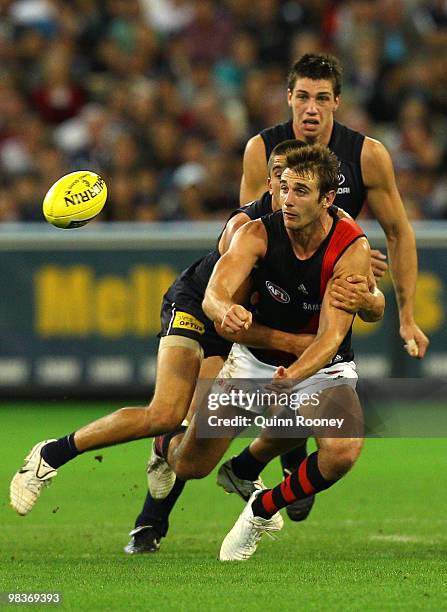 Jobe Watson of the Bombers handballs during the round three AFL match between the Carlton Blues and the Essendon Bombers at the Melbourne Cricket...