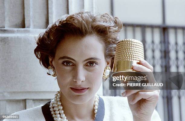 French model Ines de la Fressange poses with the "golden thimble" awarded by Chanel on July 31, 1986 in Paris. Reserved to the best collection of the...