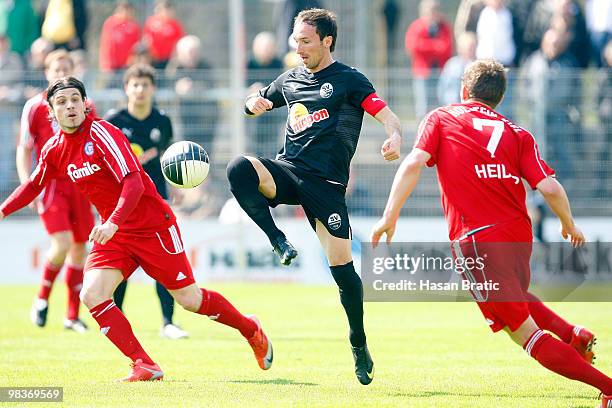 Roberto Pinto from Sandhausen battles for the ball with Massimo Cannizzaro from Kiel and Marc Heider from Kiel during the Third Liga match between SV...