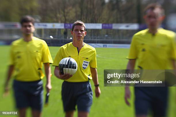 Referee Michael Kempter enters the field for the Third League match between SV Sandhausen and Holstein Kiel at Hardtwald Stadion on April 10, 2010 in...