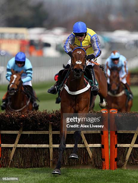 Peddlers Cross ridden by Jason Maguire clears the last fence on their way to victory in The John Smith's Mersey Novices' Hurdle Race at Aintree...