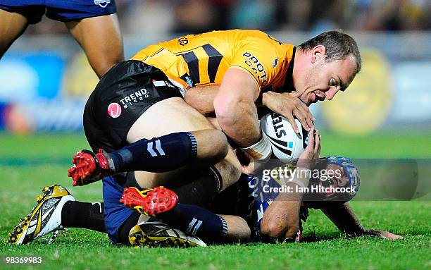 Johnathan Thurston of the Cowboys lies on the ground after being accidently injured by Gareth Ellis of the Tigers during the round five NRL match...