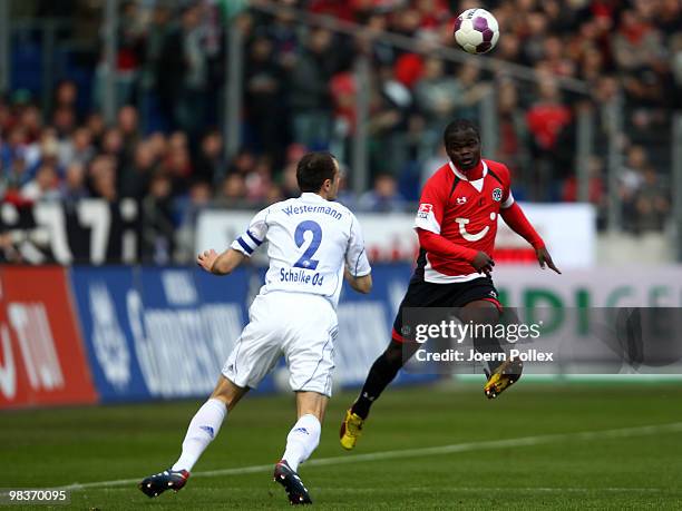 Didier Ya Konan of Hannover and Heiko Westermann of Schalke compete for the ball during the Bundesliga match between Hannover 96 and FC Schalke 04 at...