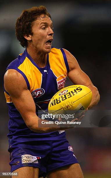 Bradd Dalziell of the Eagles handballs during the round three AFL match between the North Melbourne Kangaroos and the West Coast Eagles at Etihad...