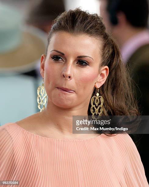 Coleen Rooney sticks out her tongue as she attends the John Smith's Grand National horse racing meet at Aintree Racecourse on April 10, 2010 in...