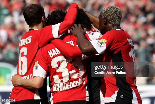 Manuel Schmiedebach of Hannover celebrates with his team mates after scoring his team's first goal during the Bundesliga match between Hannover 96...