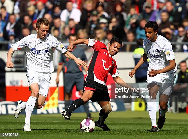 Elson Falco da Silva of Hannover and Ivan Rakitic and Joel Matip of Schalke compete for the ball during the Bundesliga match between Hannover 96 and...