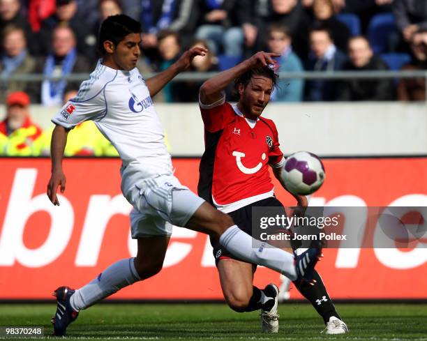 Christian Schulz of Hannover and Joel Matip of Schalke compete for the ball during the Bundesliga match between Hannover 96 and FC Schalke 04 at AWD...