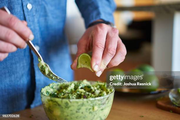 adding lime juice to guacamole - lime juice stock pictures, royalty-free photos & images