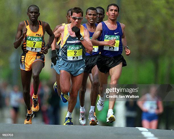 Abdelkader El Mouaziz Winner of the London Marathon running along side Antonio Pinto and Jadhet Kosgei during the Flora London Marathon in London,...