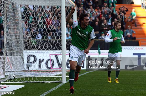 Claudio Pizarro of Bremen celebrates after he scores his team's opening goal during the Bundesliga match between Werder Bremen and SC Freiburg at the...