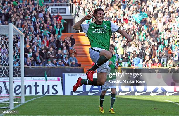 Claudio Pizarro of Bremen celebrates after he scores his team's opening goal during the Bundesliga match between Werder Bremen and SC Freiburg at the...