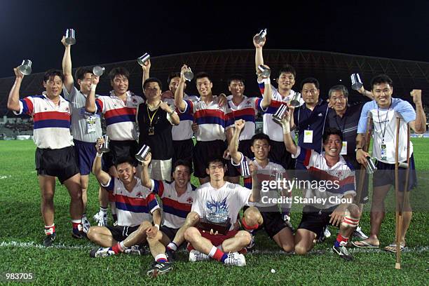 The Korean Team celebrates with their Bowl Trophy win over England during the last day of the World Rugby Sevens Series, Malaysia Sevens at the...