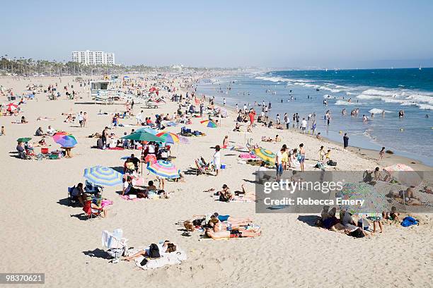 crowded santa monica beach - santa monica stock-fotos und bilder