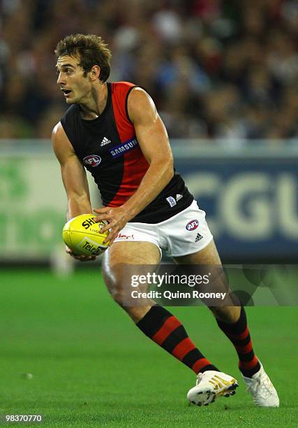 Jobe Watson of the Bombers looks to handball during the round three AFL match between the Carlton Blues and the Essendon Bombers at the Melbourne...