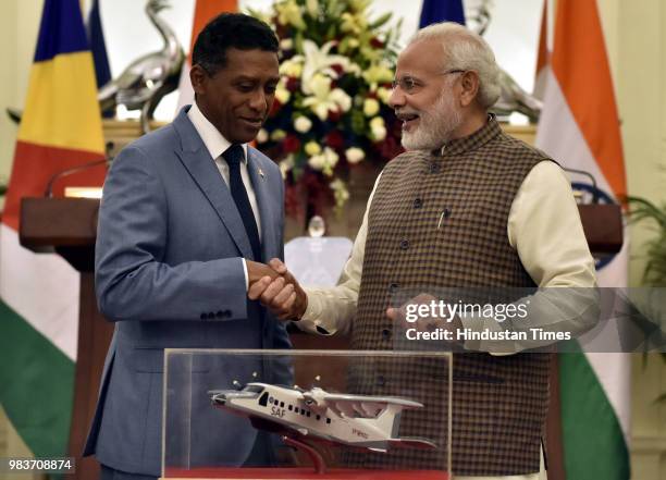 Prime Minister Narendra Modi shakes hand after handing over the replica of Dornier Aircraft to President of Seychelles Danny Antoine Rollen Faure,...