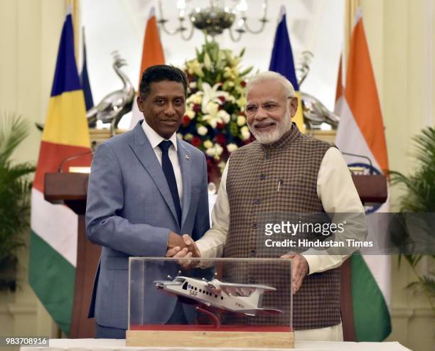 Prime Minister Narendra Modi shakes hand after handing over the replica of Dornier Aircraft to President of Seychelles Danny Antoine Rollen Faure,...