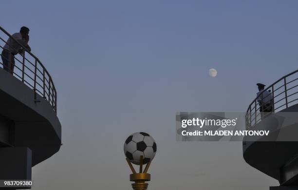 The moon rises in the sky ahead of the Russia 2018 World Cup Group B football match between Iran and Portugal at the Mordovia Arena in Saransk on...