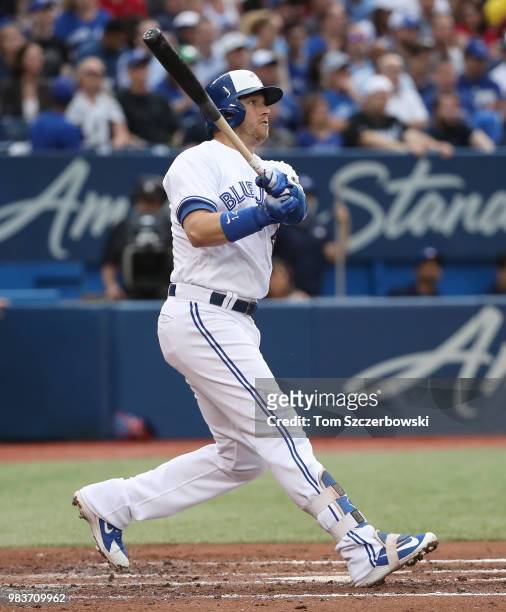 Justin Smoak of the Toronto Blue Jays hits a double in the third inning during MLB game action against the Atlanta Braves at Rogers Centre on June...