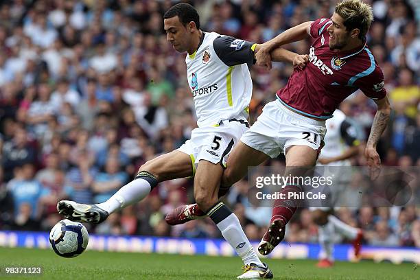 Valon Behrami of West Ham United tackles Anton Ferdinand of Sunderland during the Barclays Premier League match between West Ham United and...