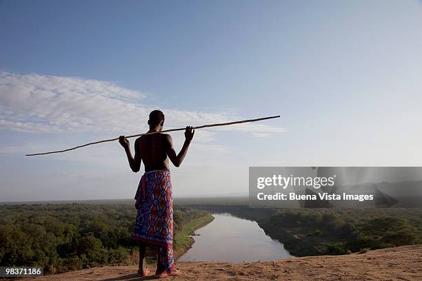 karo young watching omo river - ethiopia stockfoto's en -beelden