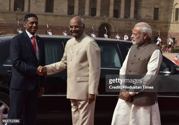 President Ram Nath Kovind welcomes his Seychelles's counterpart Danny Antoine Rollen Faure as Prime Minister Narendra Modi looks on at the ceremonial...