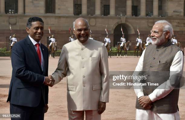 President Ram Nath Kovind welcomes his Seychelles's counterpart Danny Antoine Rollen Faure as Prime Minister Narendra Modi looks on at the ceremonial...