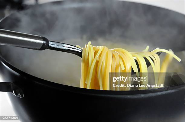 al dente spaghetti - boiling pasta stock pictures, royalty-free photos & images