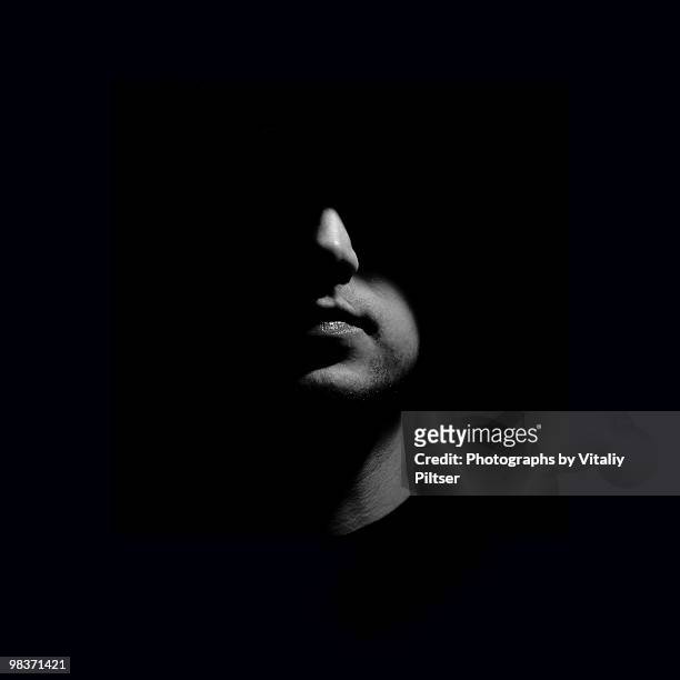 portrait of a man with face half lit. - unrecognizable person stock pictures, royalty-free photos & images