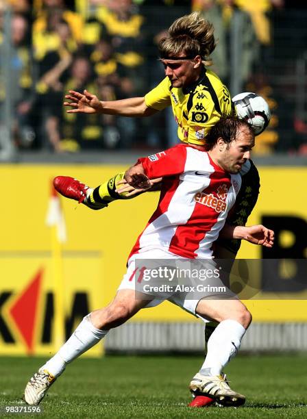 Filip Trojan of Mainz is challenged by Marcel Schmelzer of Dortmund during the Bundesliga match between FSV Mainz 05 and Borussia Dortmund at the...