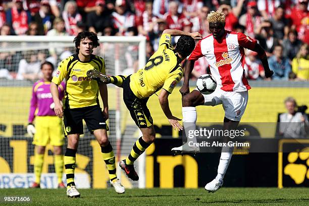 Aristide Bance of Mainz is challenged by Nuri Sahin and Mats Hummels of Dortmund during the Bundesliga match between FSV Mainz 05 and Borussia...