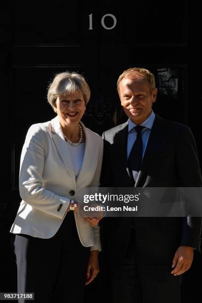 British Prime Minister Theresa May greets President of the European Council Donald Tusk as he arrives for a meeting at Downing Street on June 25,...