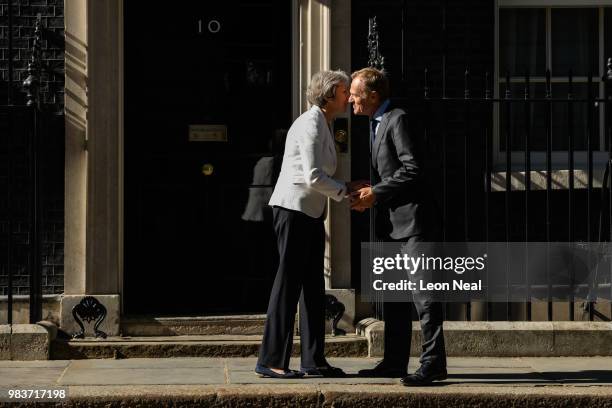 British Prime Minister Theresa May greets President of the European Council Donald Tusk as he arrives for a meeting at Downing Street on June 25,...