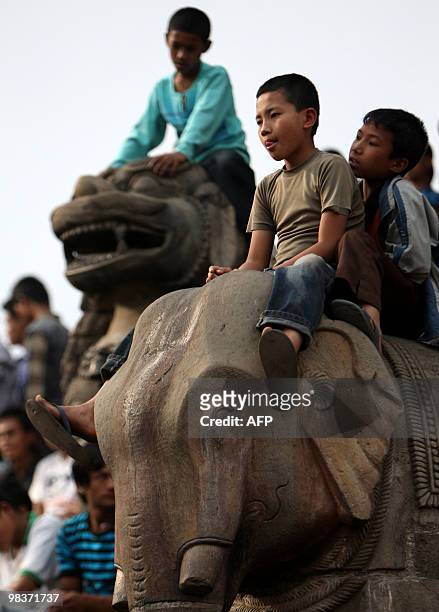 Nepalese Hindu youths watch as unseen devotees pull a wooden chariot as they take part in Bisket Jatra, a festival held in celebration of the...