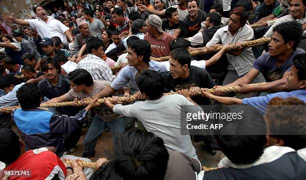 Nepalese Hindu devotees pull a wooden chariot as they take part in Bisket Jatra, a festival held in celebration of the Nepalese New Year in...