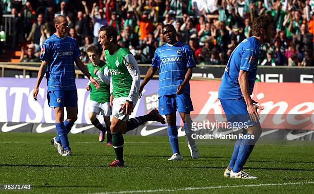 Mesut Oezil of Bremen celebrates after he scores his team's 4th goal during the Bundesliga match between Werder Bremen and SC Freiburg at the Weser...