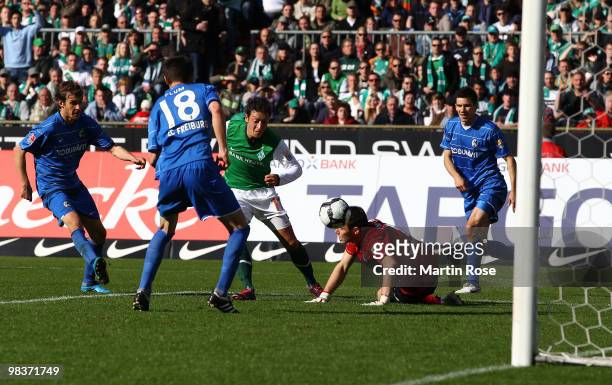Mesut Oezil of Bremen scores his team's 4th goal during the Bundesliga match between Werder Bremen and SC Freiburg at the Weser Stadium on April 10,...