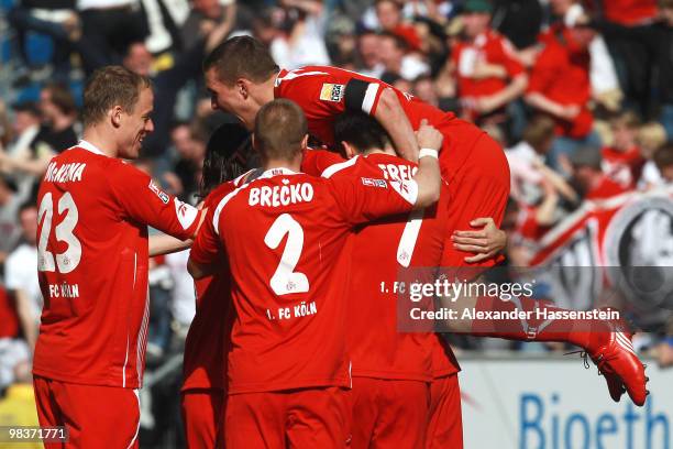 Lukas Podolski of Koeln celebrates the first team goal with his team mates during the Bundesliga match between 1899 Hoffenheim and 1. FC Koeln at...