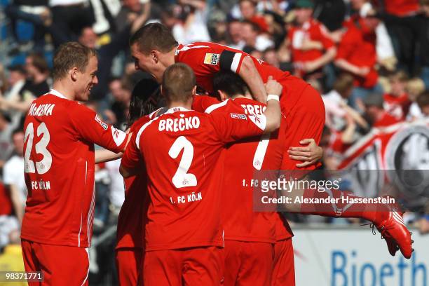 Lukas Podolski of Koeln celebrates the first team goal with his team mates during the Bundesliga match between 1899 Hoffenheim and 1. FC Koeln at...