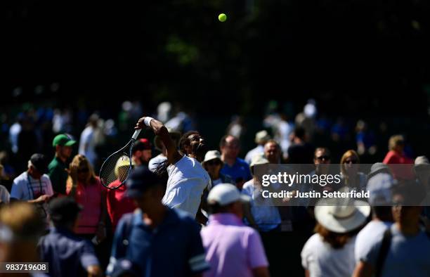 Dustin Brown of the United States serves against Stefan Kozlov of United States during the Wimbledon Lawn Tennis Championships Qualifying at The Bank...