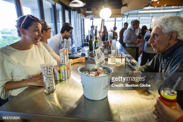Marian Leitner, left, whose company Archer Roose sells wine in cans, serves wine to guests during a weekly "drinkup" at the Venture Café in...