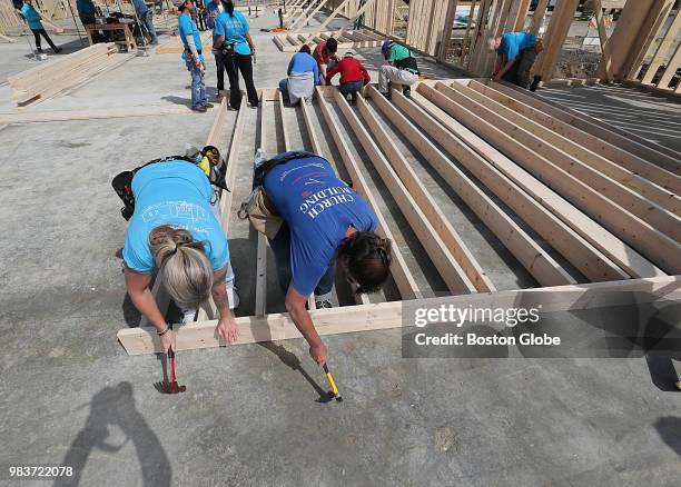 Volunteers Diane Allan from Arizona, left, and Carol Thomas from Maine hammer nails as volunteers help to build the new Chinese Bible Church of...