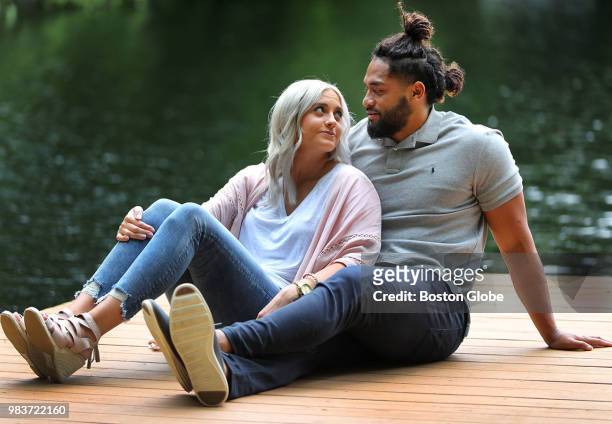 New England Patriots linebacker Harvey Langi sits with his wife Cassidy on a dock on a pond at a friend's home in Foxborough, MA on June 20, 2018....