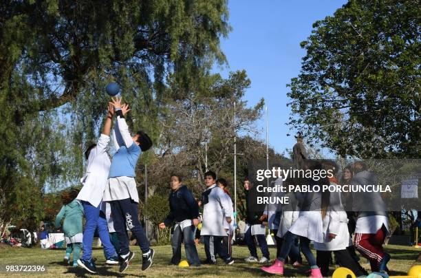 Schoolchildren play with a ball before watching the World Cup match between Uruguay and Russia on a big screen at a square in the Russian-founded...