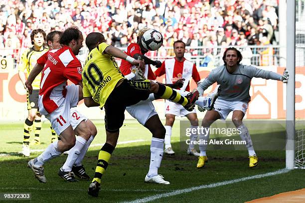 Mohamed Zidan of Dortmund is challenged by Filip Trojan and Aristide Bance of Mainz during the Bundesliga match between FSV Mainz 05 and Borussia...