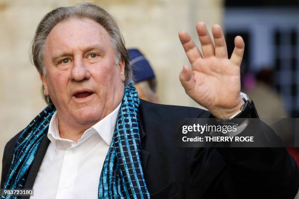 French actor Gerard Depardieu waves as he arrives at the Town Hall in Brussels for a ceremony as part of the 'Brussels International Film Festival'...