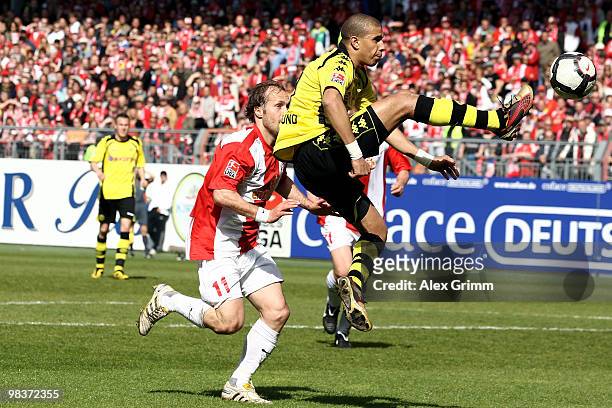 Mohamed Zidan of Dortmund is challenged by Filip Trojan of Mainz during the Bundesliga match between FSV Mainz 05 and Borussia Dortmund at the...