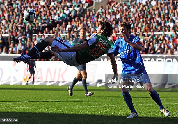 Hugo Almeida of Bremen and Heiko Butscher of Freiburg compete for the ball during the Bundesliga match between Werder Bremen and SC Freiburg at the...