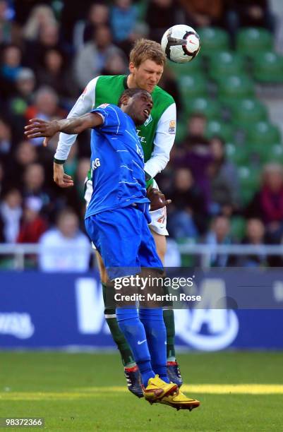 Per Mertesacker of Bremen and Cedrick Makiadi of Freiburg compete for the ball during the Bundesliga match between Werder Bremen and SC Freiburg at...